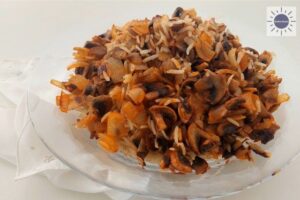 Wholegrain Rice And Mushrooms On A Glass Round Serving Plate With A Delicate Embroidered Napkin Folded On The Side.
