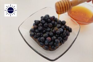 Apple Blueberry Pie Recipe - Adding The Honey To The Blueberries