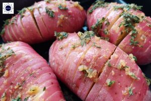 Savory Accordion Potatoes Recipe - Thyme Olive Oil Potato With Garnish In Pan