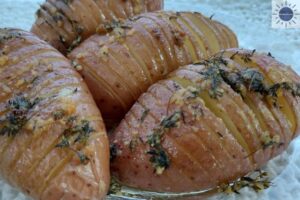 Savory Accordion Potatoes On A Serving Plate On A Lace Placemat.