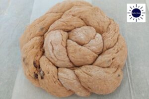 Wholegrain Honey Raisin Challah Recipe - Two Long Strands Twisted Together And Formed Into A Circle - End Tucked under