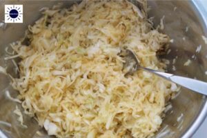 In A Large Bowl, Cabbage Mixed With Spices Using A Tablespoon .