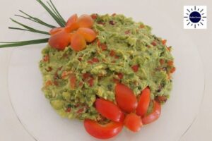 Avocado Spread With Roasted Bell Peppers Decorated With Bel Pepper Flowers In A Dish.