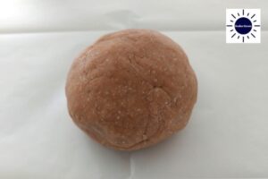 A Ball Formed From The Crust Dough On A Baking Sheet.