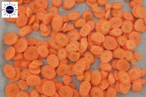 Carrot Oval Shapes Spread On A Baking Sheet in a Baking Pan.