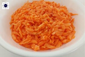 Coarsely Grated Carrots In Large Bowl.