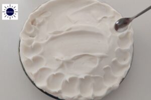 Creating A Circular Design With A Spoon On The Meringue On The Top Layer Of The Pie In The Dish.