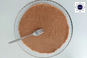 Perforating Pie Crust Dough Within Thea pie Dish With A Fork.