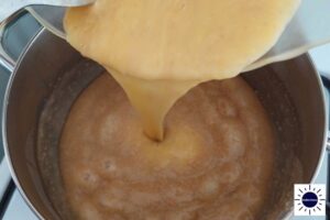 Pouring The Egg Yolk And Oat Mixture Back Into The Pot.