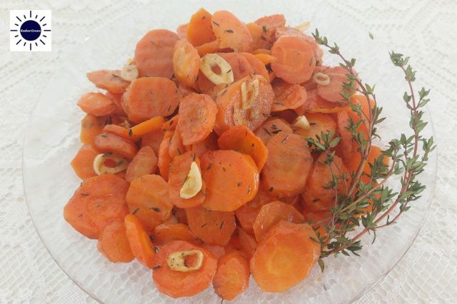 Mediterranean Roasted Carrots In Bowl Garnished With Thyme Leaves.