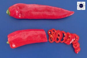 Thinly Sliced Long Sweet Peppers On Cutting Board.