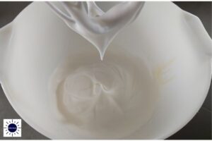 Whisked Egg Whites With Stiff Peaks In Mixing Bowl.