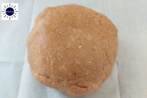 A Ball Made From The Cookie Dough On A Baking Sheet.