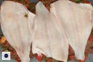 A Closeup Of The Fish Fillet Placed On Top Of Tomato Sauce With The Kosher Create Sun Logo In The Lower Left Corner.