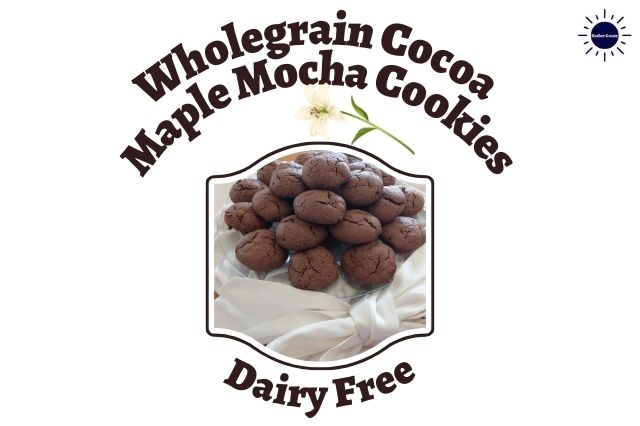 Wholegrain Cocoa Maple Mocha Cookies On A Glass Serving Plate On Top Of Bunched Silky Material With a Decorative Silky Large Bow In Front In A Decorative Frame And With A Graphic Flower Above And The Inscription Dairy Free On The Bottom And With The Kosher Create Sun Logo In The Upper Right Corner Next To The Title.