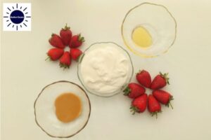 Strawberry Peanut Butter Yogurt Smoothie Ingredients In Glass Bowls and with The Strawberries Formed Into Two Flowers With The Kosher Create Sun Logo In The Upper Left Corner.