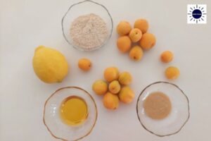 Wholegrain Almond Apricot Bars Ingredients In Glass Bowls With The Fresh Apricots Designed In Flower Shapes With The Kosher Create Sun Logo In The Upper Right Corner.