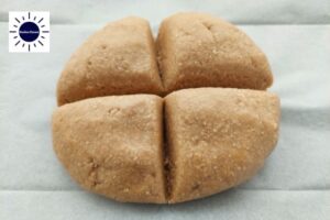 Ball Of Dough Divided Into Four Parts With The Kosher Create Sun Logo In The Upper Left Corner.