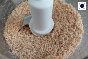 Walnuts Coarsely Blended In A Food Processor With The Kosher Create Sun Logo In The Upper Right Corner.