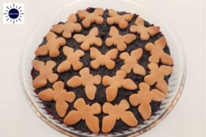 Baked Pie In The Round Glass Pie Dish With The Kosher Create Sun Logo In The Upper Left Corner.