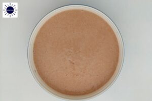 Cake Batter In A Round Baking Pan With The Kosher Create Sun Logo In The Upper Left Corner.
