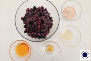 Wholegrain Lemony Blueberry Pie Filling Ingredients In Glass Bowls With The Kosher Create Sun Logo In The Lower Right Corner.