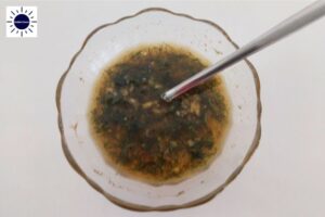 Mixtue For Marinating The Salmon In A Glass Bowl With A Spoon And With The Kosher Create Sun Logo In The Upper Left Corner