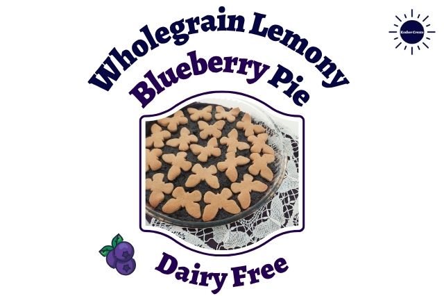 A Closeup Of A Wholegrain Lemony Blueberry Pie Decorated With Blueberry Cookies On Top In A Round Glass Pie Dish On Top Of A Lace Cloth With Blueberry Ornaments Within A Decorative Frame With The Inscription Dairy Free Below Next To A Graphic Blueberry Bunch With Leaves And With The Kosher Create Sun Logo In The Upper Right Corner Next To The Title. 