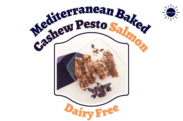 Mediterranean Baked Cashew Pesto Salmon On A Diamond Shaped Glass Serving Plate Adorned With Red Basil Leaves And A Flower Made Out Of Cashews With A Decorative Cloth On The Side Shaped Like A Basil Leaf  Within A Decorative Frame With The Inscription Dairy Free Below And With The Kosher Create Sun Logo In The Upper Right Side.