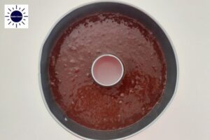 Cake Batter In Baking Pan Before Baking With The Kosher Create Sun Logo In The Upper Left Corner.