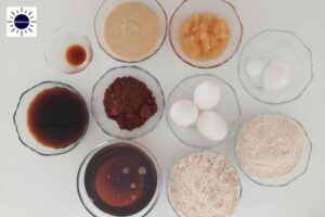 Wholegrain Dairy-Free Glazed Cocoa Cake Ingredients Arranged In Bowls.