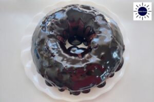 Glazed Cake Ready For Decorating With The Kosher Create Sun Logo In The Upper Right Corner.