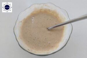 The Dressing In A Glass Bowl With A Spoon And With The Kosher Create Sun Logo In The Upper Left Corner.