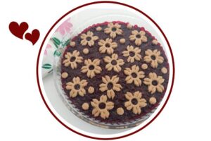 Wholegrain Mapley Cherry Pie In A Round Glass Baking Dish Decorated With A Delicate Cherry Blossom Cut Cookies Motif With A Decorative Napkin Folded In The Upper Left Side Adorned With Two Flowers That's Suited For Dessert In A Decorative Circle Adorned With Two Graphic Hearts On The Side.
